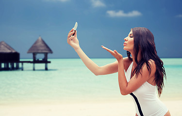 Image showing young woman taking selfie with smartphone