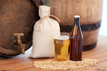 Image showing close up of beer barrel, glass, bottle and malt