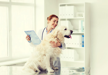 Image showing happy doctor with retriever dog at vet clinic