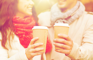 Image showing smiling couple with coffee cups in autumn park