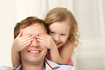 Image showing Daughter playing with father closing his eyes