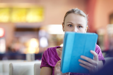 Image showing Woman in a terminal using her tablet