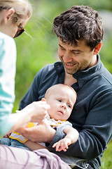 Image showing Mom and dad caring for baby