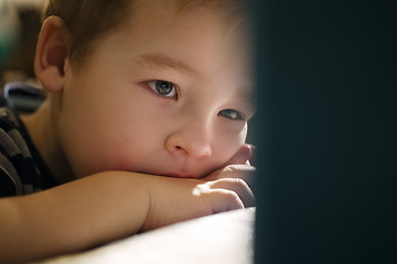 Image showing Boy watching cartoons on touchpad