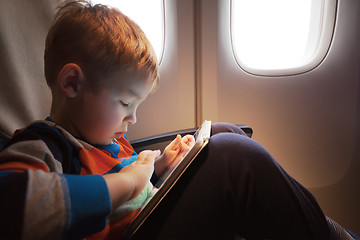 Image showing Child using tablet computer during flight