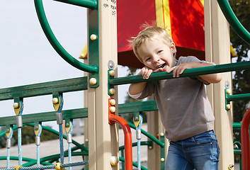 Image showing Boy on playground equipment.