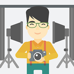 Image showing Photographer with camera in photo studio.