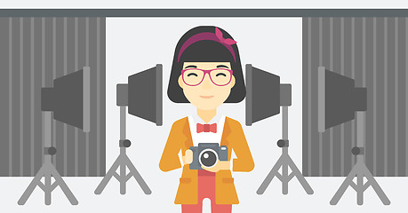 Image showing Smiling photographer holding camera.