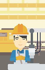 Image showing Man working on industrial drilling machine.