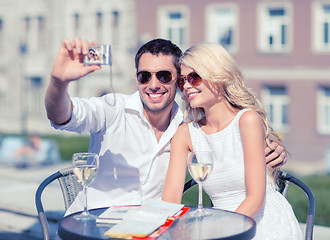 Image showing couple taking photo in cafe