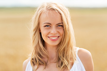 Image showing smiling young woman in white on cereal field