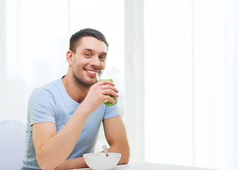 Image showing happy man having breakfast at home