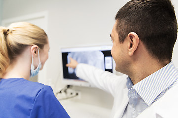 Image showing close up of dentist and assistant at dental clinic