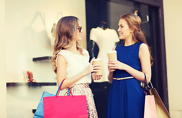 Image showing young women with shopping bags and coffee at shop