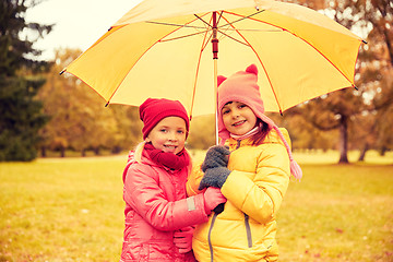 Image showing happy little girls with umbrella in autumn park