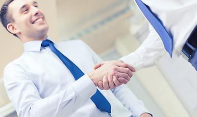 Image showing two businessmen shaking hands in office