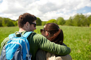 Image showing happy couple with backpacks hiking outdoors