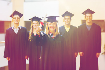 Image showing group of smiling students in mortarboards