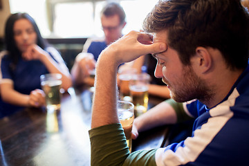 Image showing soccer fans watching football match at bar or pub