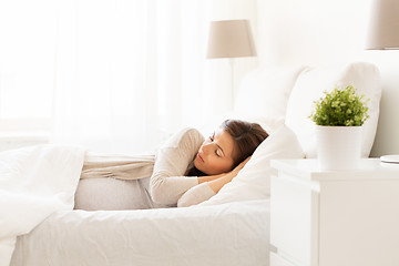 Image showing happy pregnant woman sleeping in bed at home