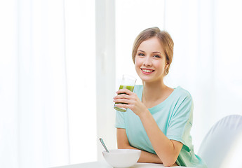 Image showing happy woman having breakfast at home