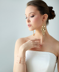 Image showing beautiful asian woman with earrings and bracelet