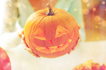 Image showing close up of woman with pumpkins at home