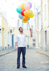 Image showing man with colorful balloons in the city
