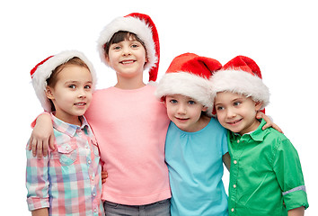 Image showing happy little children in santa hats hugging