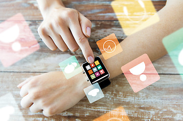 Image showing close up of hands setting smart watch with icons