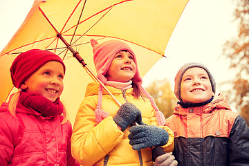 Image showing happy children with umbrella in autumn park