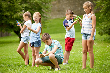 Image showing kids with smartphones playing game in summer park