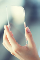 Image showing close up of woman with transparent smartphone