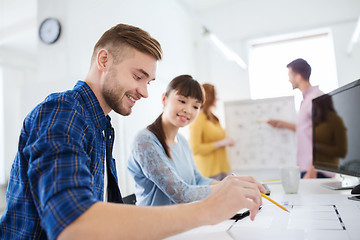 Image showing creative team with blueprint at office