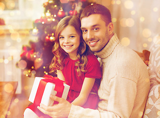 Image showing smiling father and daughter holding gift box