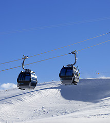 Image showing Gondola lift on ski resort at windy sun day