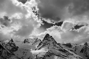 Image showing Black and white view on evening mountains in sunlight clouds