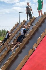Image showing Athlete gets on inclined wall by means of bar