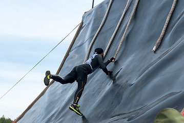Image showing Sportsman storms big wall in extrim race. Tyumen