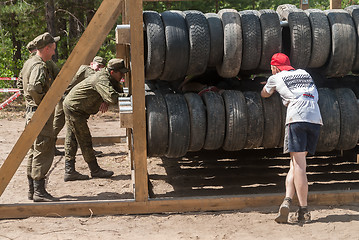 Image showing Sportsmen move between old tires. Tyumen