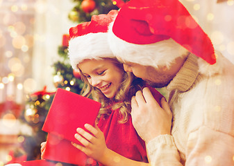 Image showing smiling father and daughter opening gift box