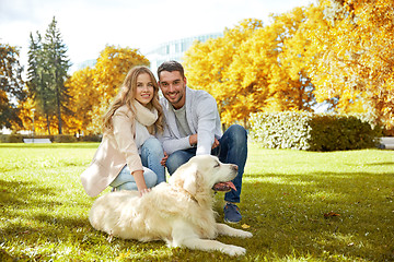 Image showing happy couple with labrador dog walking in city