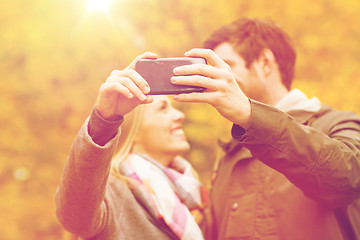 Image showing couple taking selfie with smartphone in park