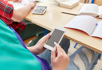 Image showing student girl with smartphone texting at school