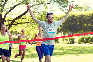 Image showing happy young male runner winning on race finish