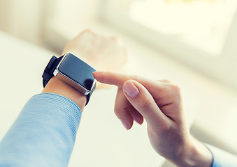 Image showing close up of hands setting smart watch