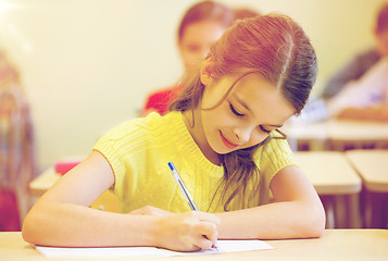 Image showing group of school kids writing test in classroom