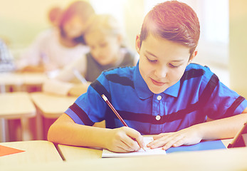 Image showing group of school kids writing test in classroom