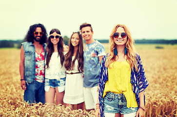 Image showing smiling young hippie friends on cereal field
