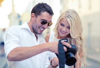 Image showing smiling couple with photo camera